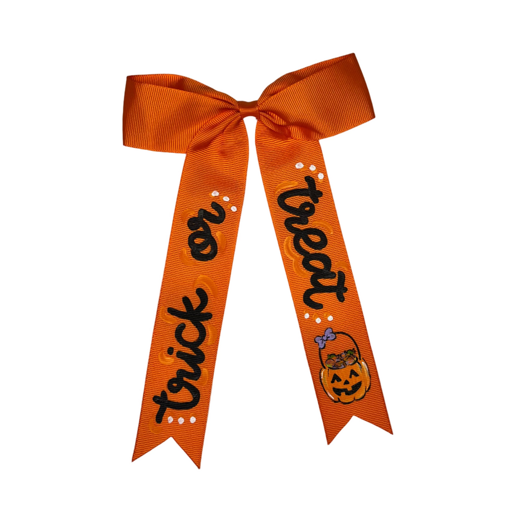 Orange bow with 'trick or treat' text on a white background